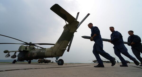 Leteckí technici pripravujú vrtuľník Mi-28 na let počas cvičenia vrtuľníkového pluku. Leteckí technici pripravujú vrtuľník Mi-28 na let počas cvičenia vrtuľníkového pluku. - Sputnik International